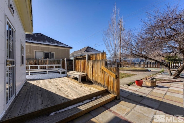 wooden terrace featuring a patio area