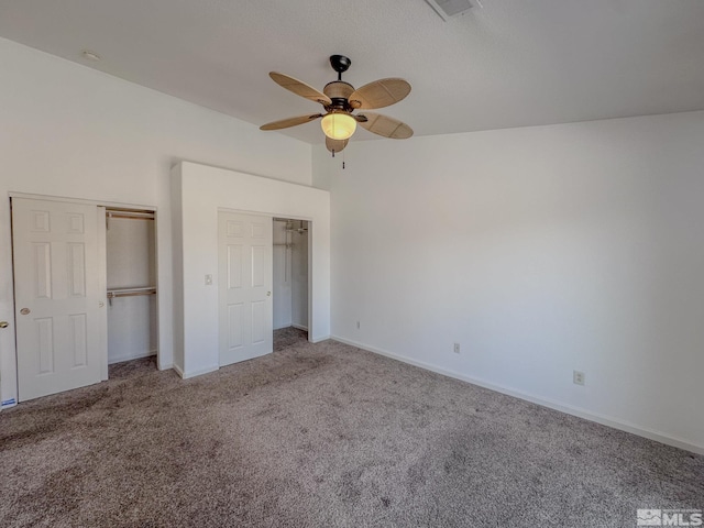 unfurnished bedroom featuring ceiling fan and carpet