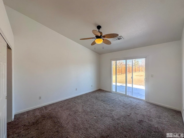 unfurnished room with dark colored carpet, lofted ceiling, and ceiling fan