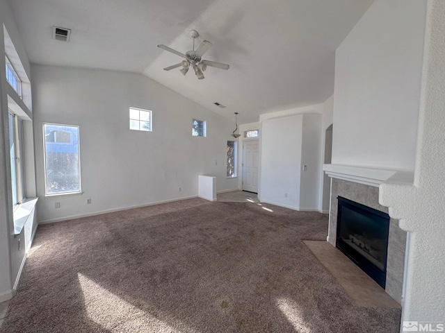 unfurnished living room featuring dark colored carpet, high vaulted ceiling, and ceiling fan