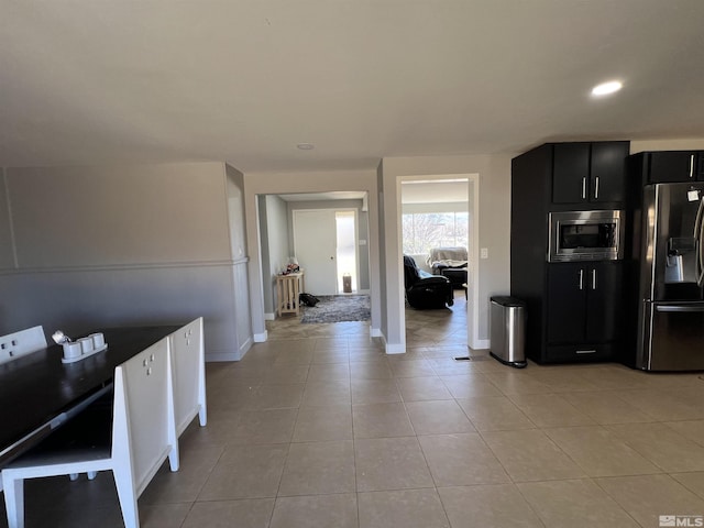 kitchen with stainless steel appliances and light tile patterned flooring