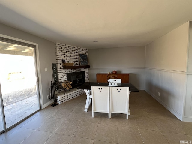 tiled dining space with a fireplace