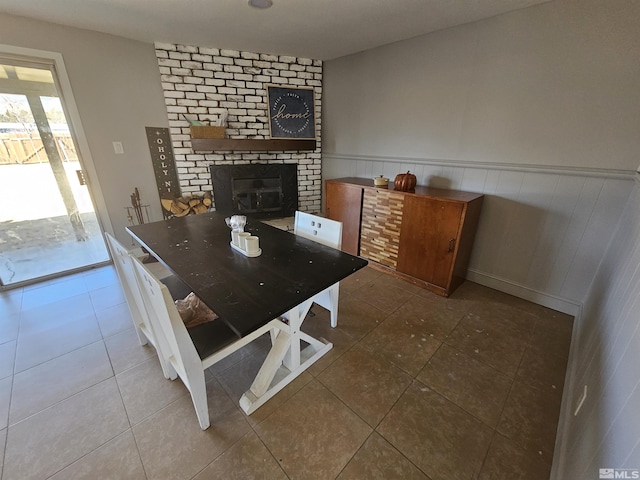 tiled dining space with a fireplace