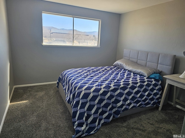 bedroom featuring a mountain view and dark carpet