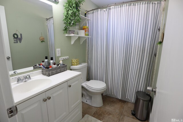 bathroom with a shower with curtain, vanity, toilet, and tile patterned flooring