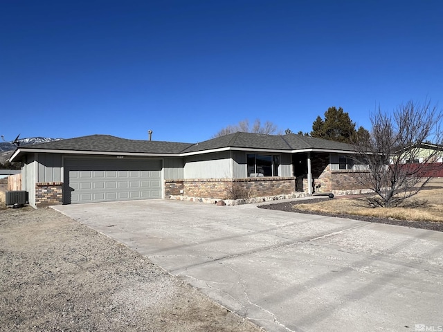 view of front of house with a garage and central air condition unit