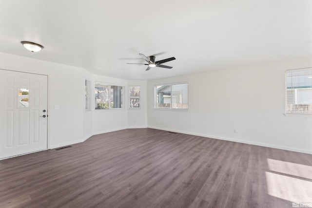 interior space with dark wood-type flooring and ceiling fan