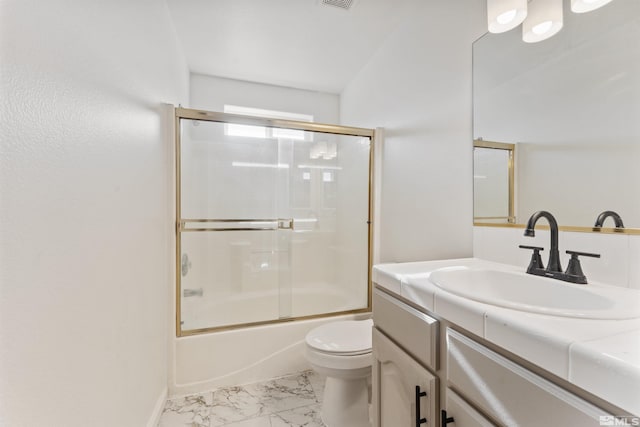 full bathroom featuring vanity, shower / bath combination with glass door, and toilet