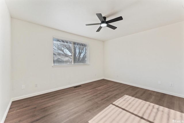 spare room featuring dark hardwood / wood-style floors and ceiling fan