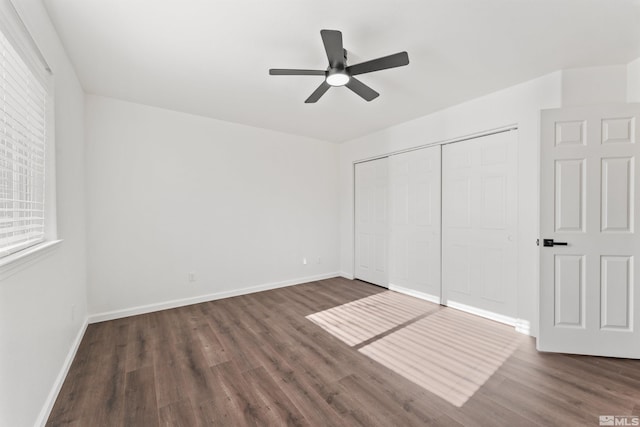 unfurnished bedroom featuring dark hardwood / wood-style flooring, a closet, and ceiling fan