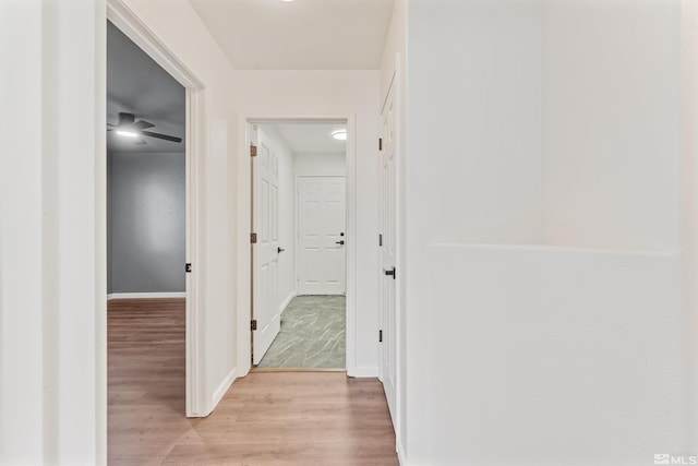 hallway with light hardwood / wood-style flooring