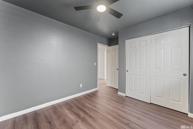 unfurnished bedroom with a closet, ceiling fan, and light wood-type flooring