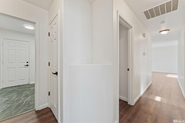 corridor featuring dark hardwood / wood-style floors