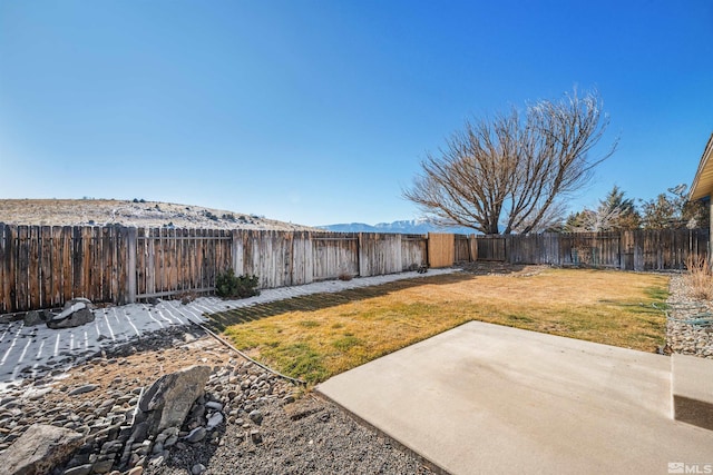 view of yard with a mountain view and a patio