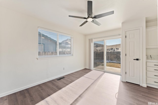 spare room featuring wood-type flooring and ceiling fan