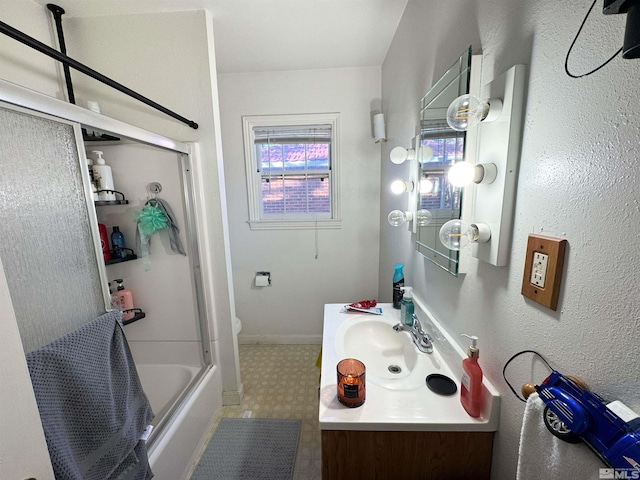 full bathroom featuring vanity, toilet, shower / bath combination with glass door, and a healthy amount of sunlight