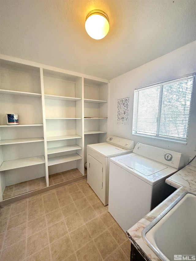 washroom featuring separate washer and dryer and sink