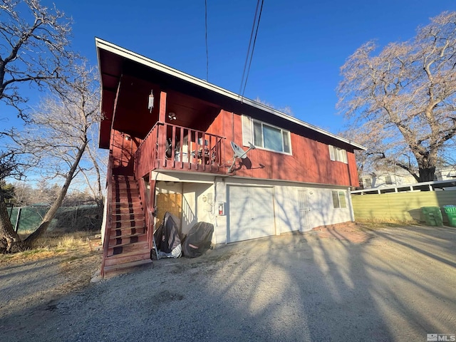 rear view of house featuring a garage