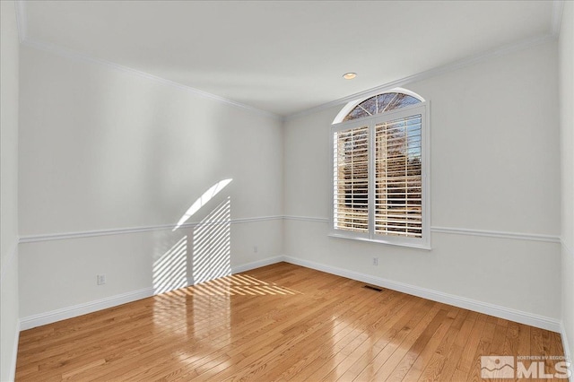 unfurnished room featuring wood-type flooring and ornamental molding