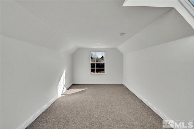 bonus room featuring lofted ceiling and carpet flooring