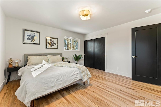 bedroom featuring a closet and light wood-type flooring