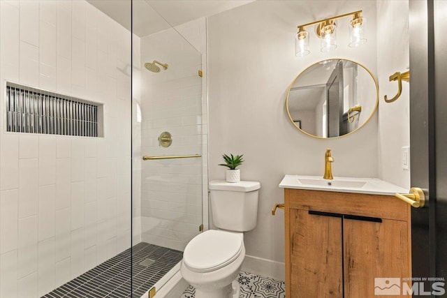 bathroom with vanity, a shower with shower door, and toilet