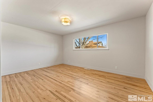 unfurnished room with light wood-type flooring