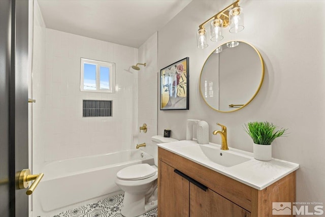 full bathroom featuring tiled shower / bath combo, vanity, and toilet