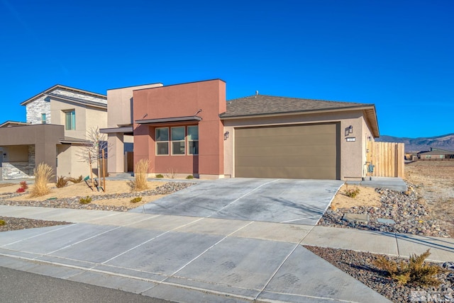 view of front of home with a garage and a mountain view