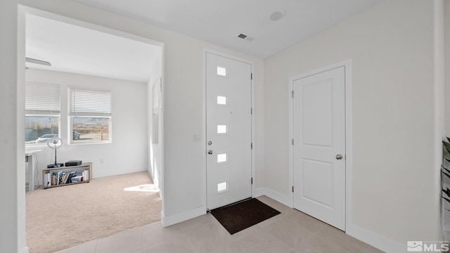 entrance foyer featuring light carpet