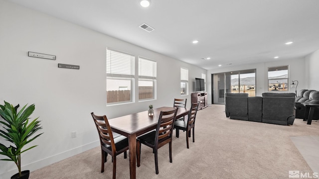 carpeted dining space featuring plenty of natural light