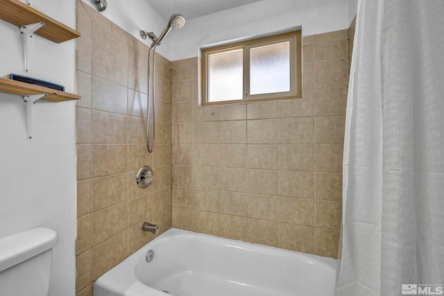 bathroom with shower / tub combo with curtain and toilet