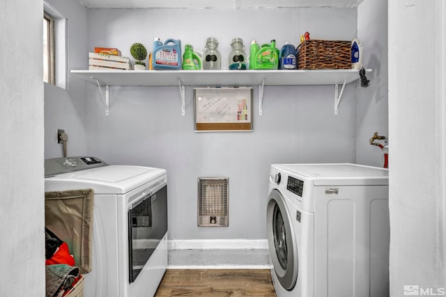 laundry room with hardwood / wood-style flooring and washer and dryer