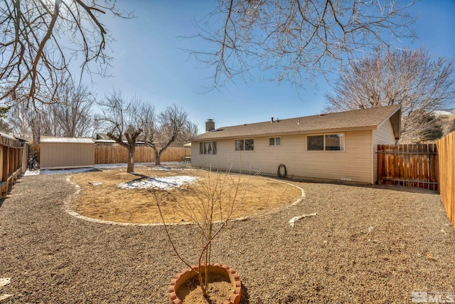 rear view of property featuring a shed