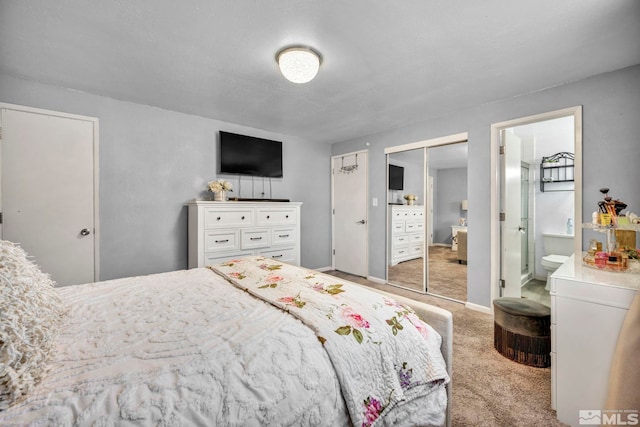 carpeted bedroom featuring ensuite bath and a closet