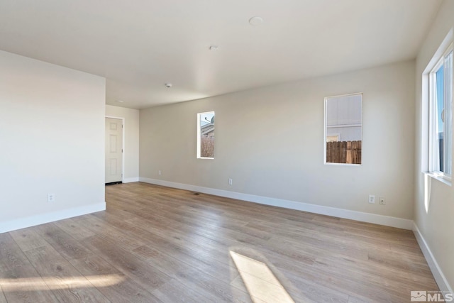 spare room featuring light hardwood / wood-style flooring