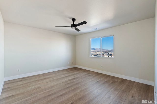 spare room featuring ceiling fan and light wood-type flooring