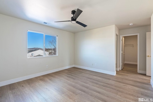 spare room featuring ceiling fan and light wood-type flooring