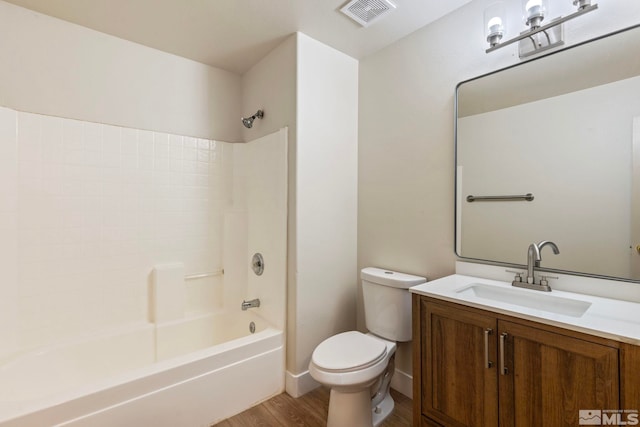 full bathroom featuring toilet, vanity, bathtub / shower combination, and hardwood / wood-style flooring