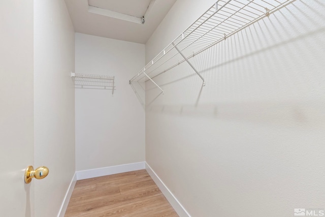 walk in closet featuring wood-type flooring