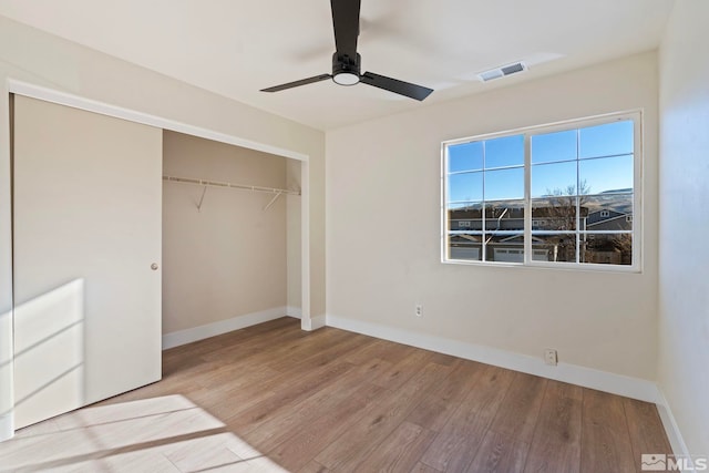 unfurnished bedroom with ceiling fan, light hardwood / wood-style floors, and a closet