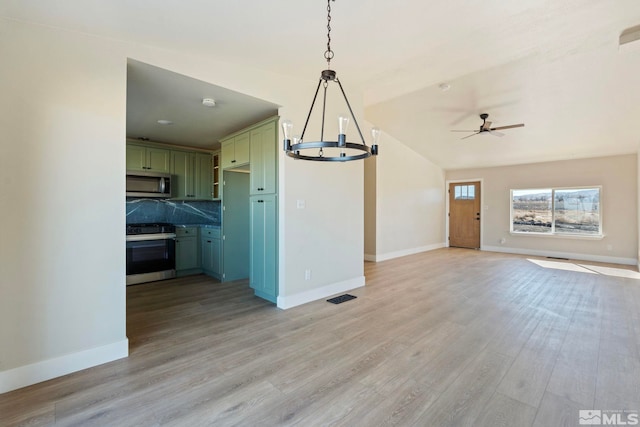 unfurnished living room with lofted ceiling, ceiling fan with notable chandelier, and light hardwood / wood-style flooring