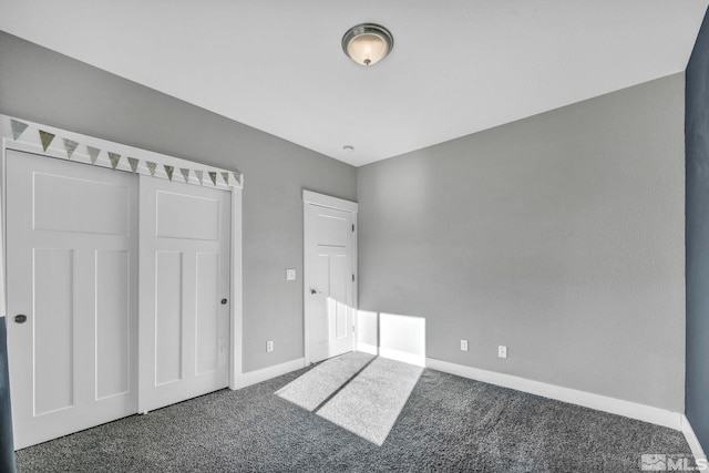 unfurnished bedroom featuring carpet flooring and baseboards