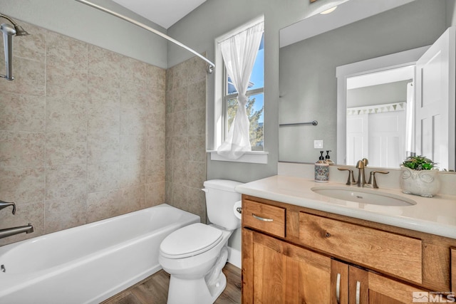 bathroom featuring vanity, shower / tub combination, toilet, and wood finished floors