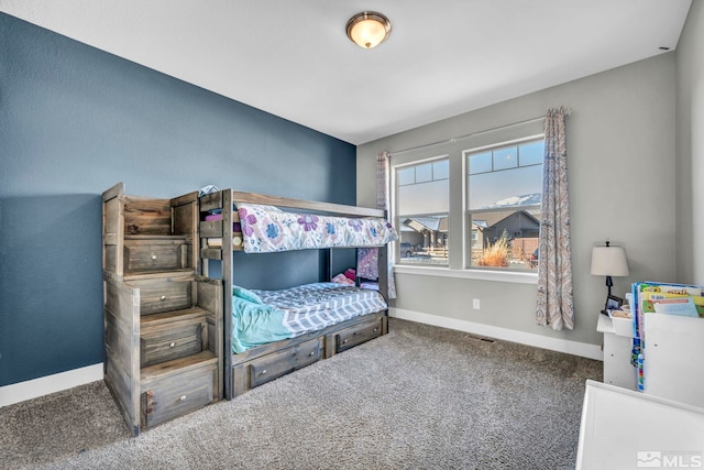 carpeted bedroom featuring visible vents and baseboards