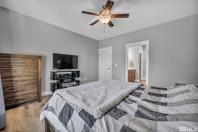 bedroom featuring ceiling fan, baseboards, and light wood-style floors