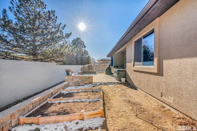 view of yard with a patio area, a garden, and a fenced backyard