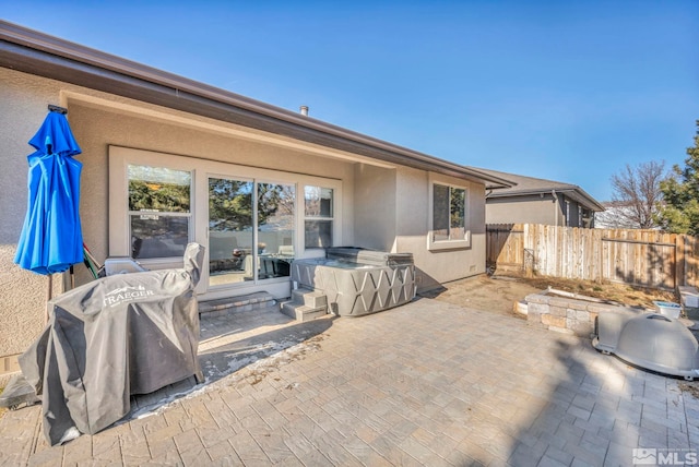 view of patio / terrace with a grill and fence