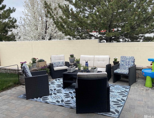 view of patio with fence and an outdoor hangout area