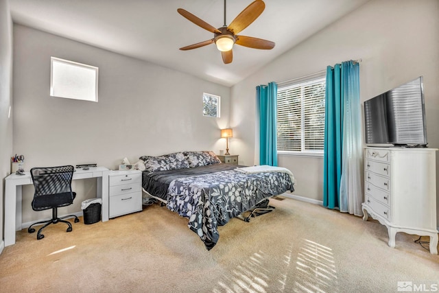 bedroom with vaulted ceiling, light colored carpet, and ceiling fan